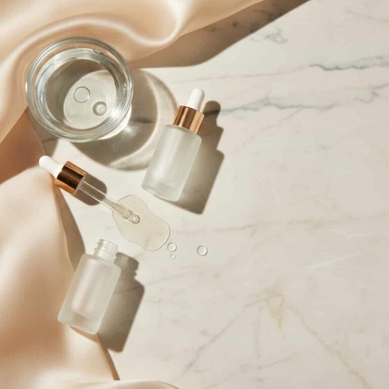 Best Hyaluronic Acid Serums for Dry Skin flat lay on marble background for dry skin hydration skincare blog